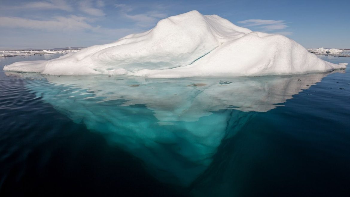 pale arctic sea ice meeting open ocean water at the floe edge