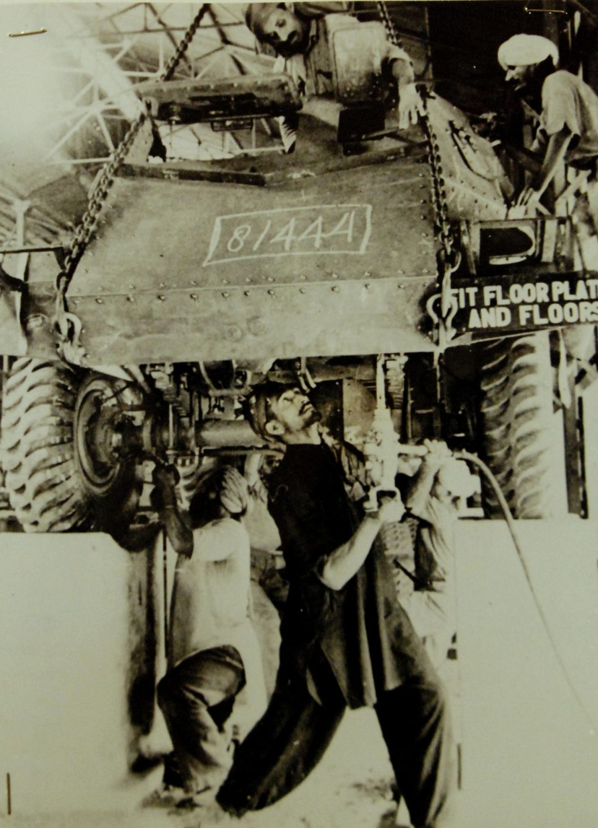 Workers on a bright factory assembly line
